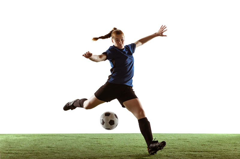 Woman Footballer Volleying The Ball